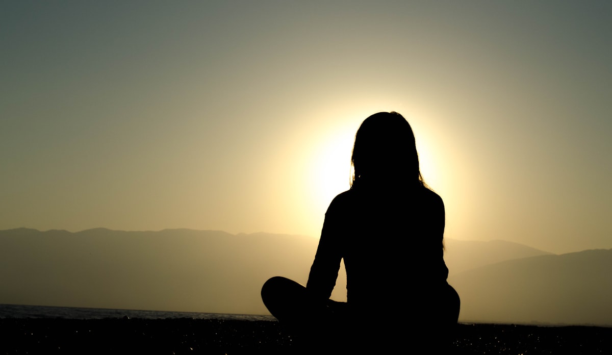 Woman practicing yoga meditation in peaceful setting